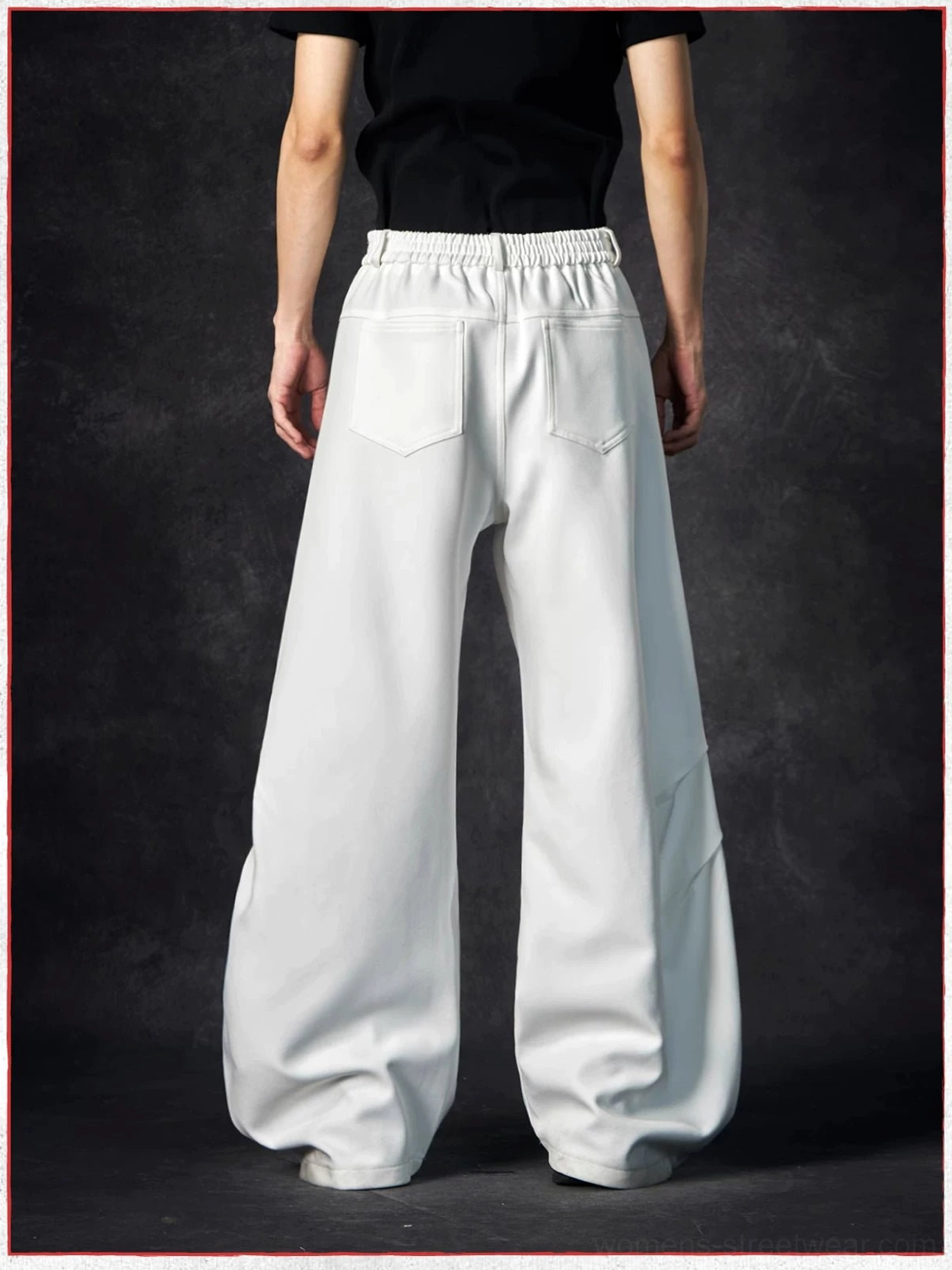 Back view of white wave contour wide-leg trousers showing the elasticated waist panel, back patch pockets, and curved side seams