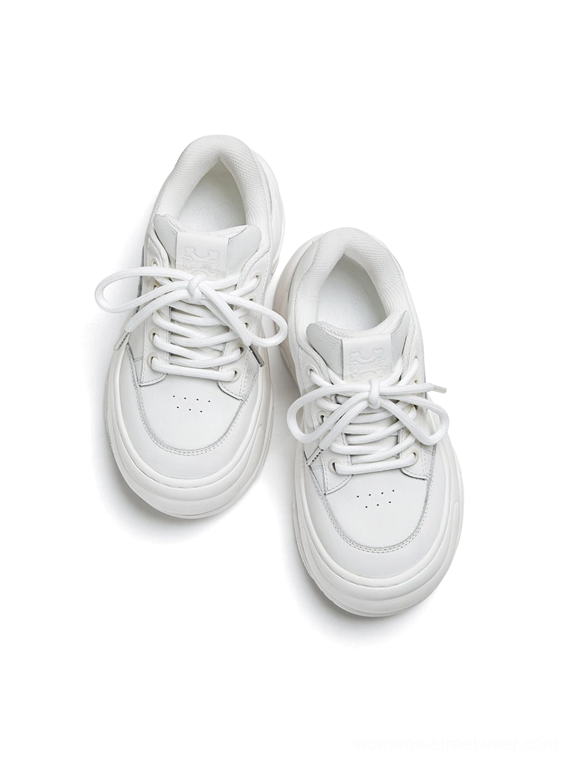 Top-down front view of white wave platform sneakers with lace-up vamp perforated toe box and smooth monochrome finish
