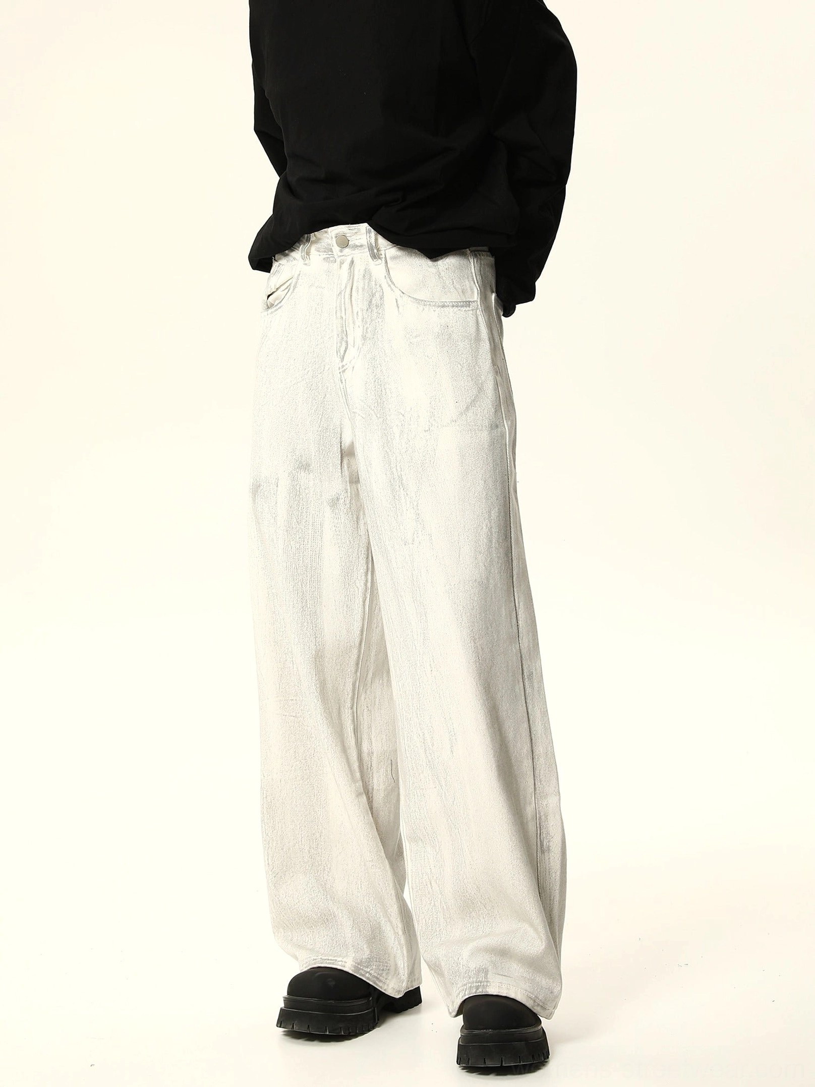 Rear side view of faded white wide leg baggy jeans showing classic back pockets and loose relaxed denim silhouette