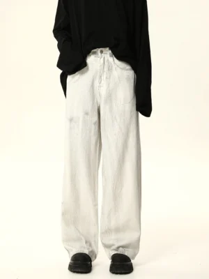Front full-body view of white wide leg baggy jeans with washed gray denim, high waist, black long sleeve top, and platform shoes