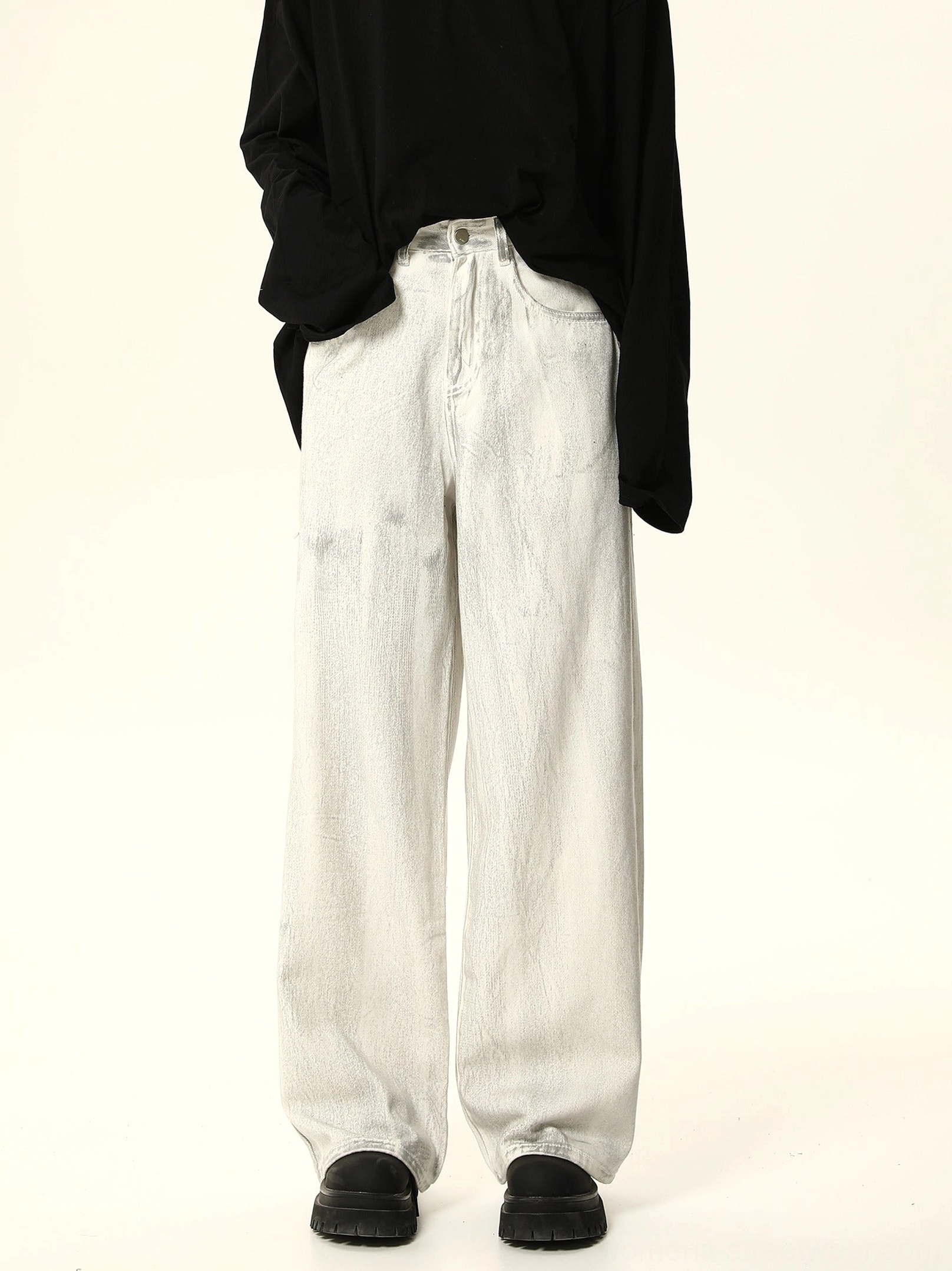 Front full-body view of white wide leg baggy jeans with washed gray denim, high waist, black long sleeve top, and platform shoes