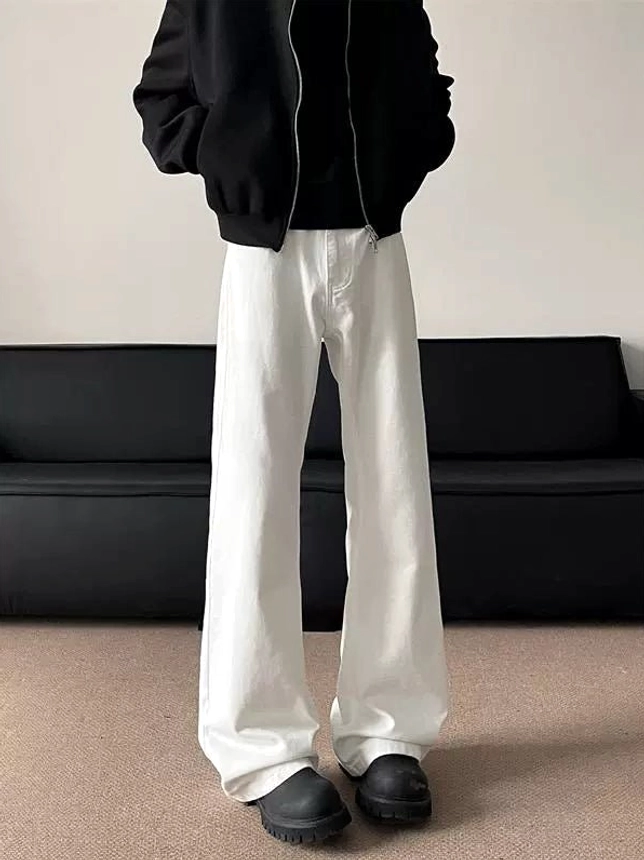 Front right side view of bright white flared streetwear jeans with wide legs and extra-long denim length