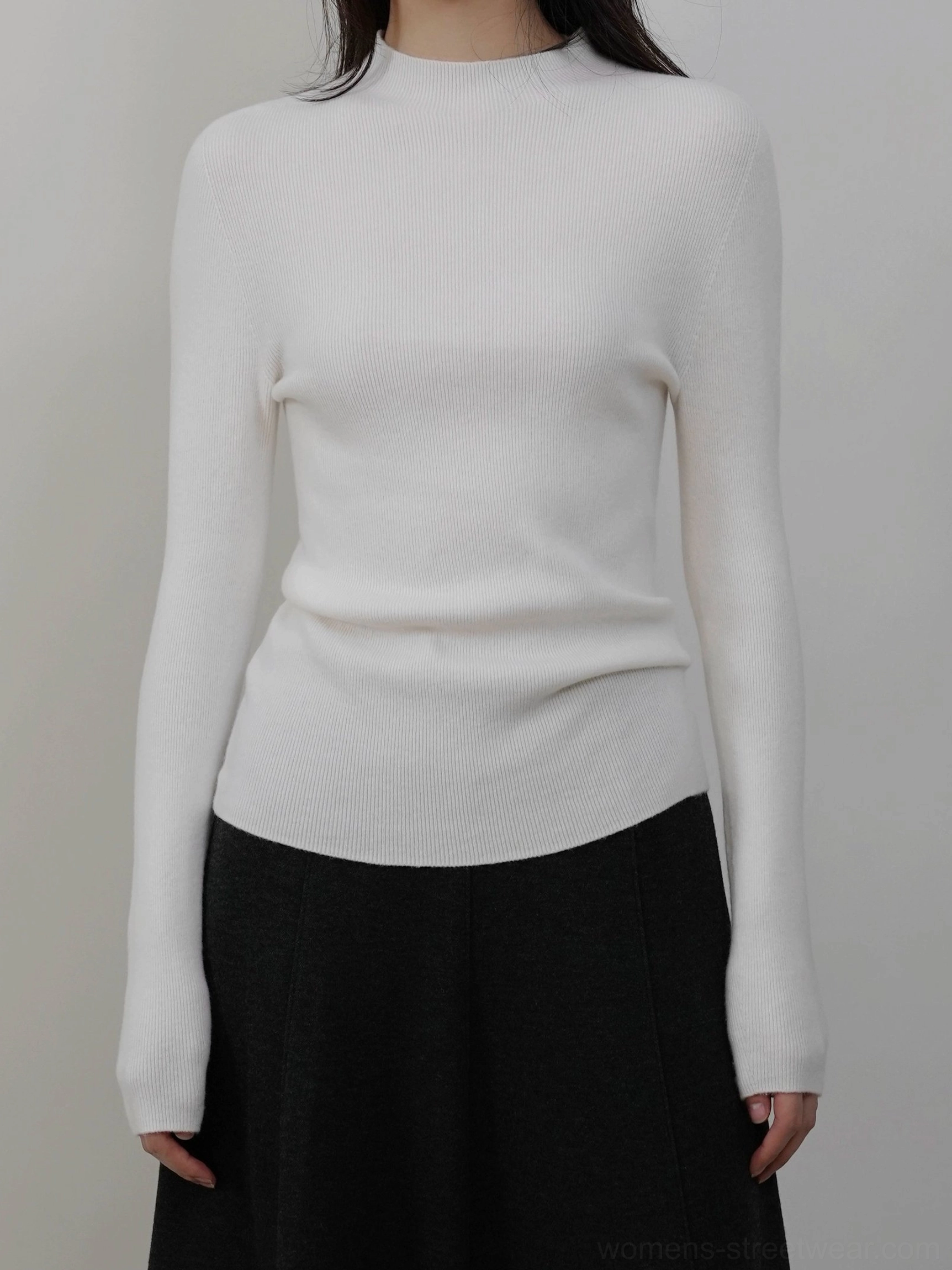 White women's mock neck knit sweater with a fitted lightweight design for clean minimalist layering