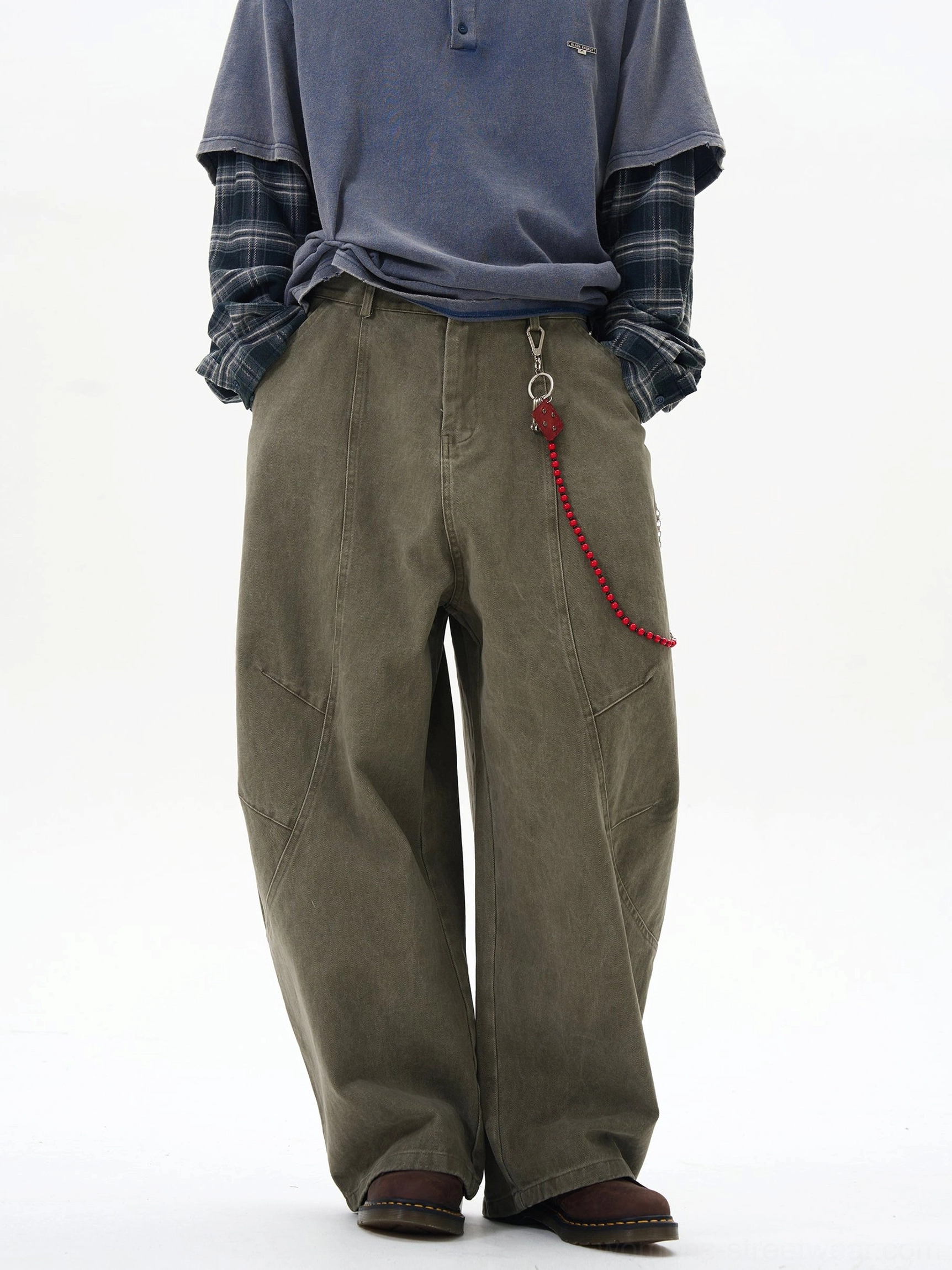 Olive green wide-leg cargo pants with red beaded chain detail shown in a front full-body streetwear studio look