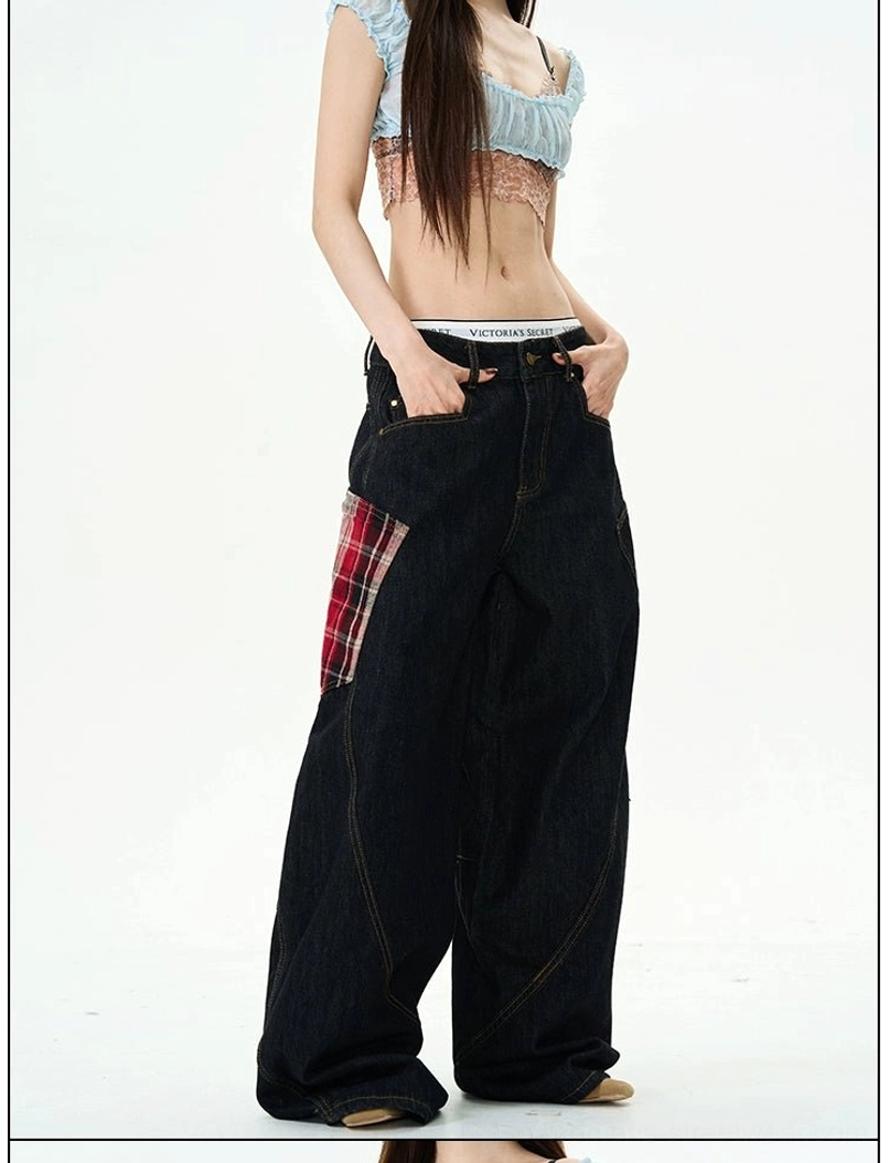 Three-quarter front view of wide-leg denim cargo pants with red plaid thigh patch, loose fit, and contrast topstitching
