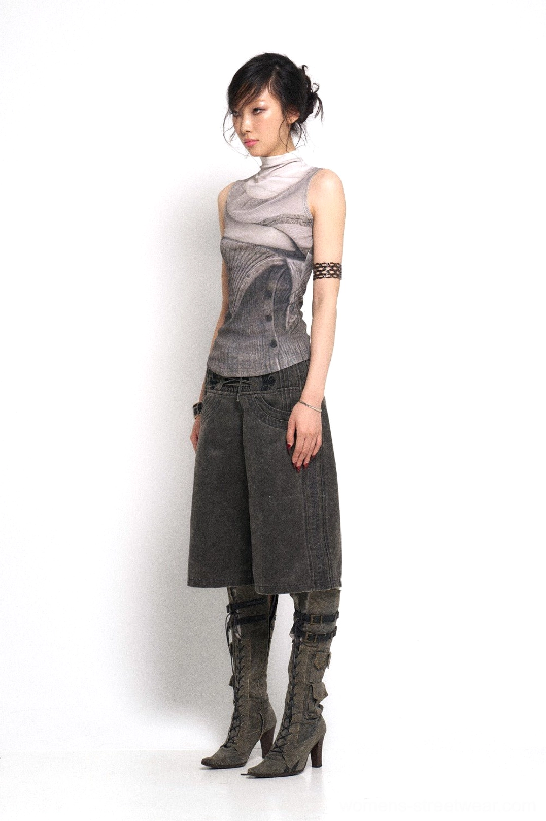 Side view of wide-leg denim culotte pants styled with a printed top, retro accessories, and lace-up boots for a Korean streetwear fashion outfit