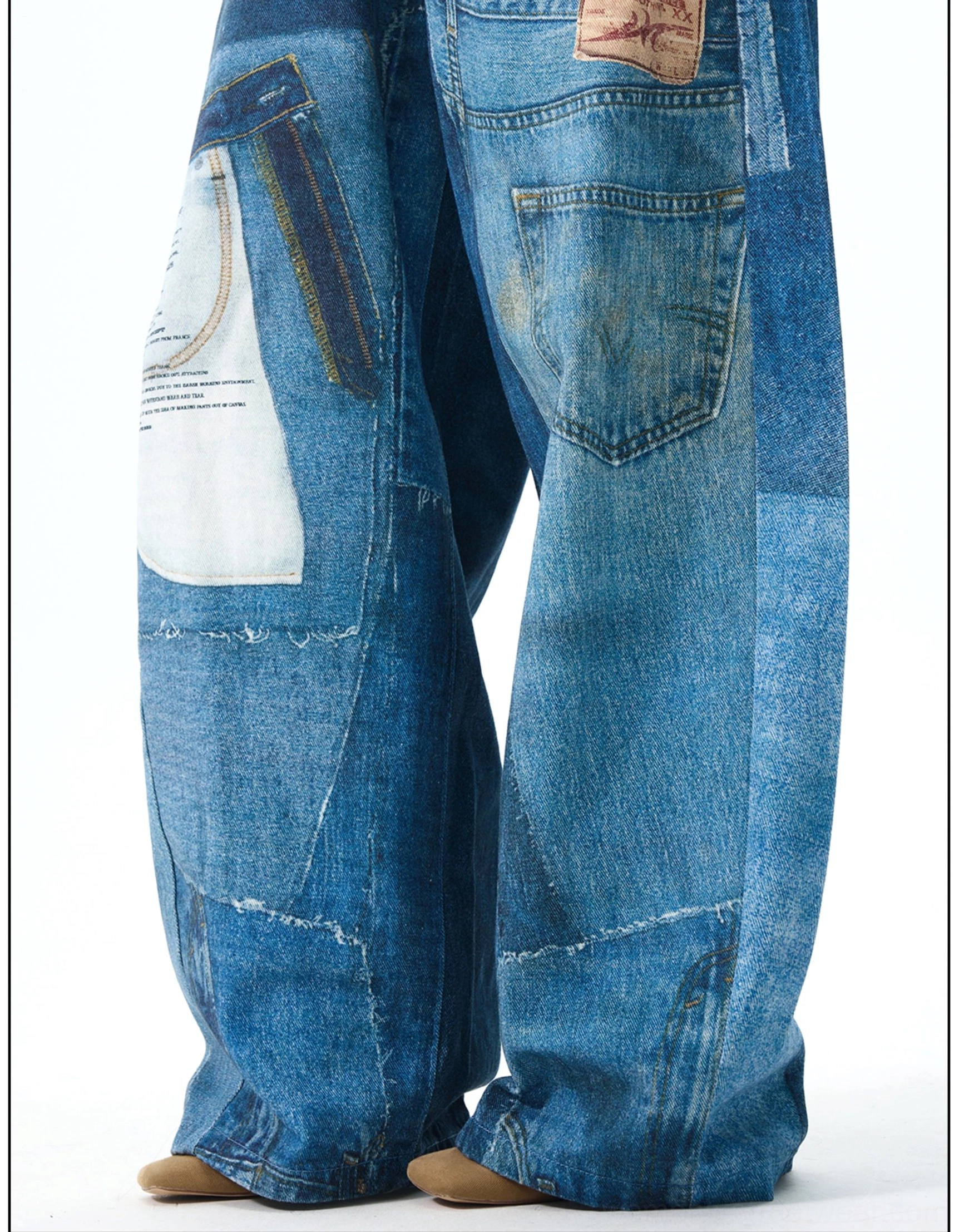 Close-up side view of wide leg patchwork jeans showing printed patch pocket, raw panel seams, faded vintage denim wash, and relaxed hem