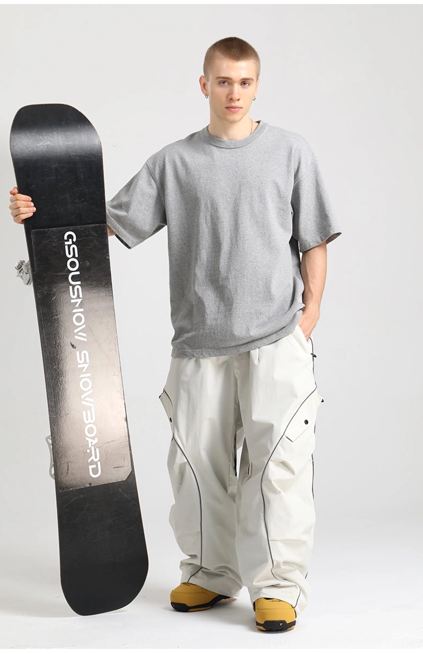 Wide-leg reflective snowboard pants with utility cargo pocket and winter streetwear design details