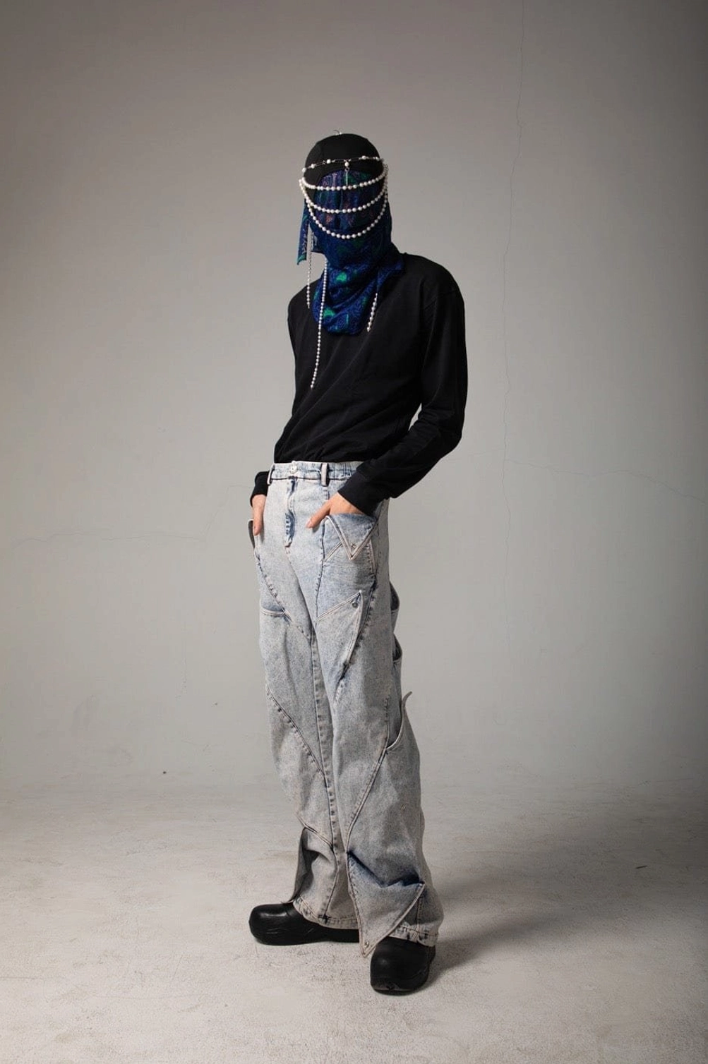 Side view of wide leg shark fin panel jeans showing full-length layered denim construction and acid wash finish