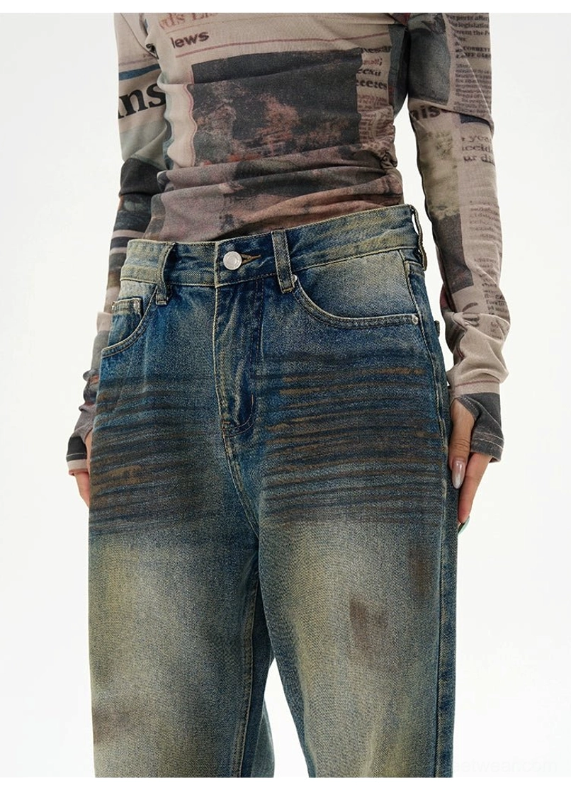 Wide-leg vintage denim jeans with ripped detailing, faded blue color, and oversized casual streetwear silhouette