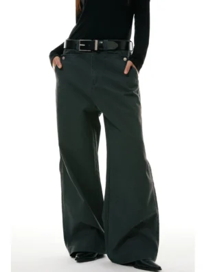 Dark olive green wide-leg workwear denim jeans worn with a black turtleneck and leather belt in a low-angle front streetwear outfit view