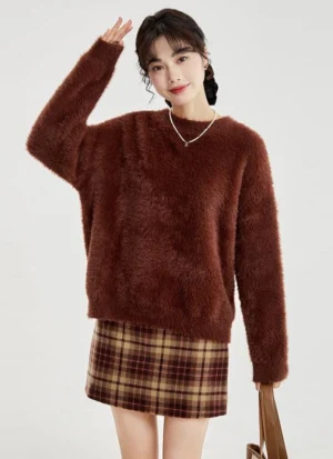 Fuzzy round neck sweater in wine red styled with a plaid skirt in a Korean streetwear studio outfit