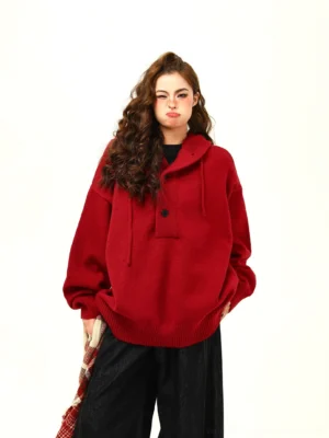 Wine red oversized hooded knit pullover sweater styled with black wide-leg pants and a plaid scarf in a relaxed Korean streetwear outfit