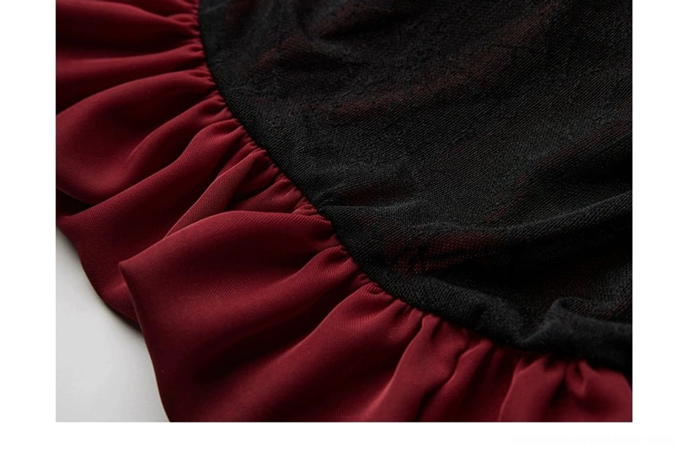 Side detail of neatly sewn wine red ruffle attached to black gothic maxi skirt