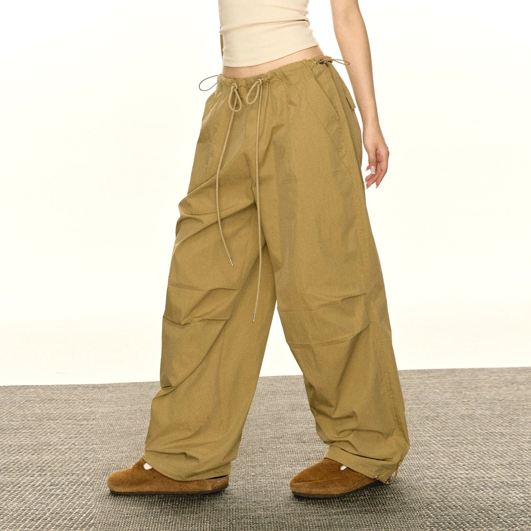 Women's adjustable hem parachute cargo pants in khaki green colorway with drawstring waist and loose wide-leg fit