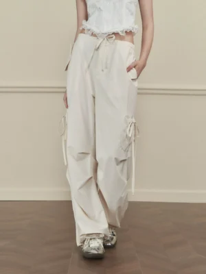 Women's apricot side-tie wide-leg cargo pants with drawstring waist and utility pockets styled with a white cropped top