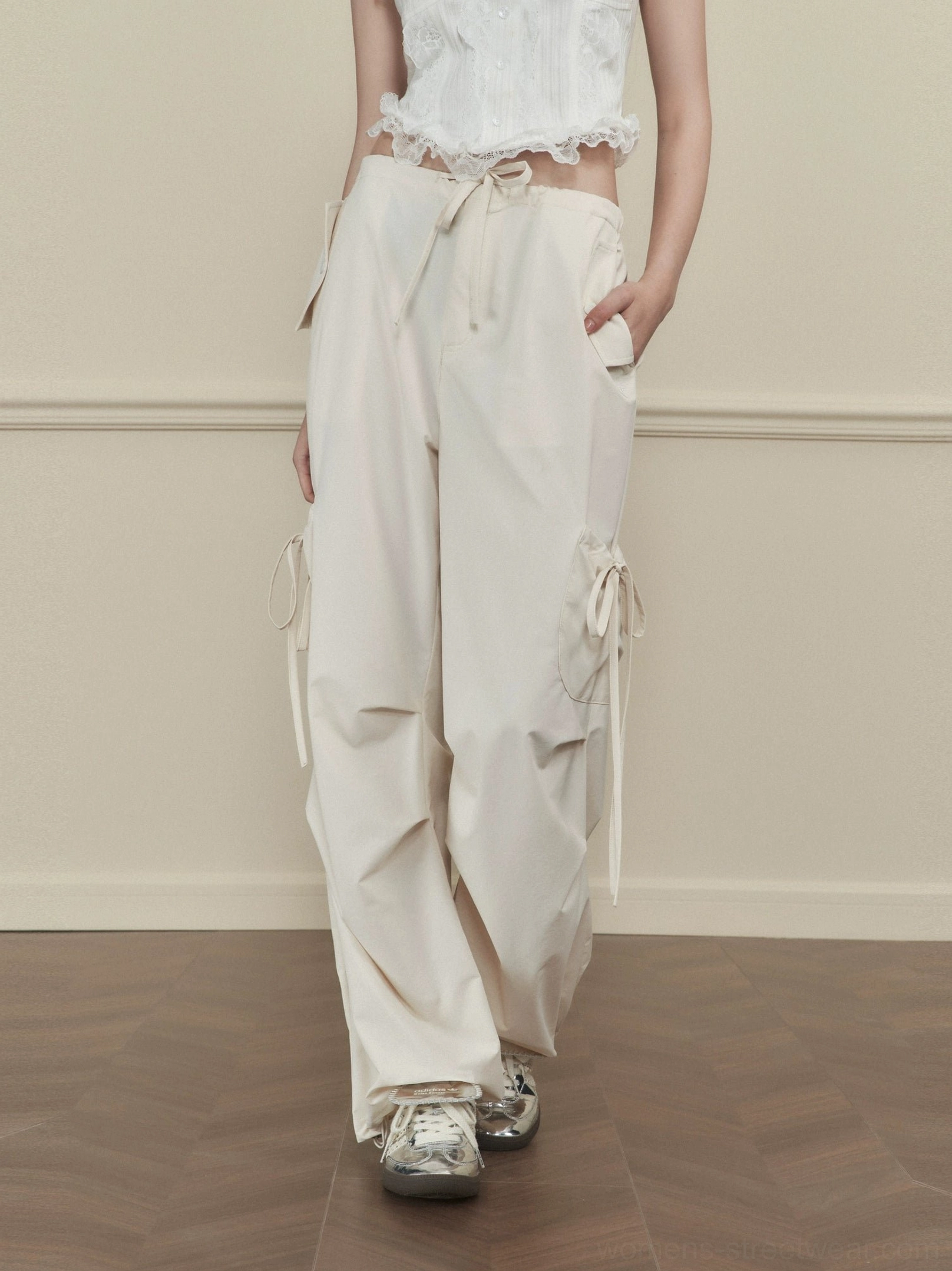 Women's apricot side-tie wide-leg cargo pants with drawstring waist and utility pockets styled with a white cropped top