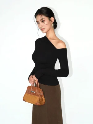 Black asymmetric one-shoulder ruched knit top side view with fitted long sleeves