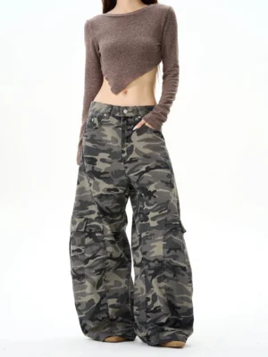 Front full-body view of women wearing high-waisted baggy camouflage cargo pants with a wide-leg streetwear silhouette and cropped brown top