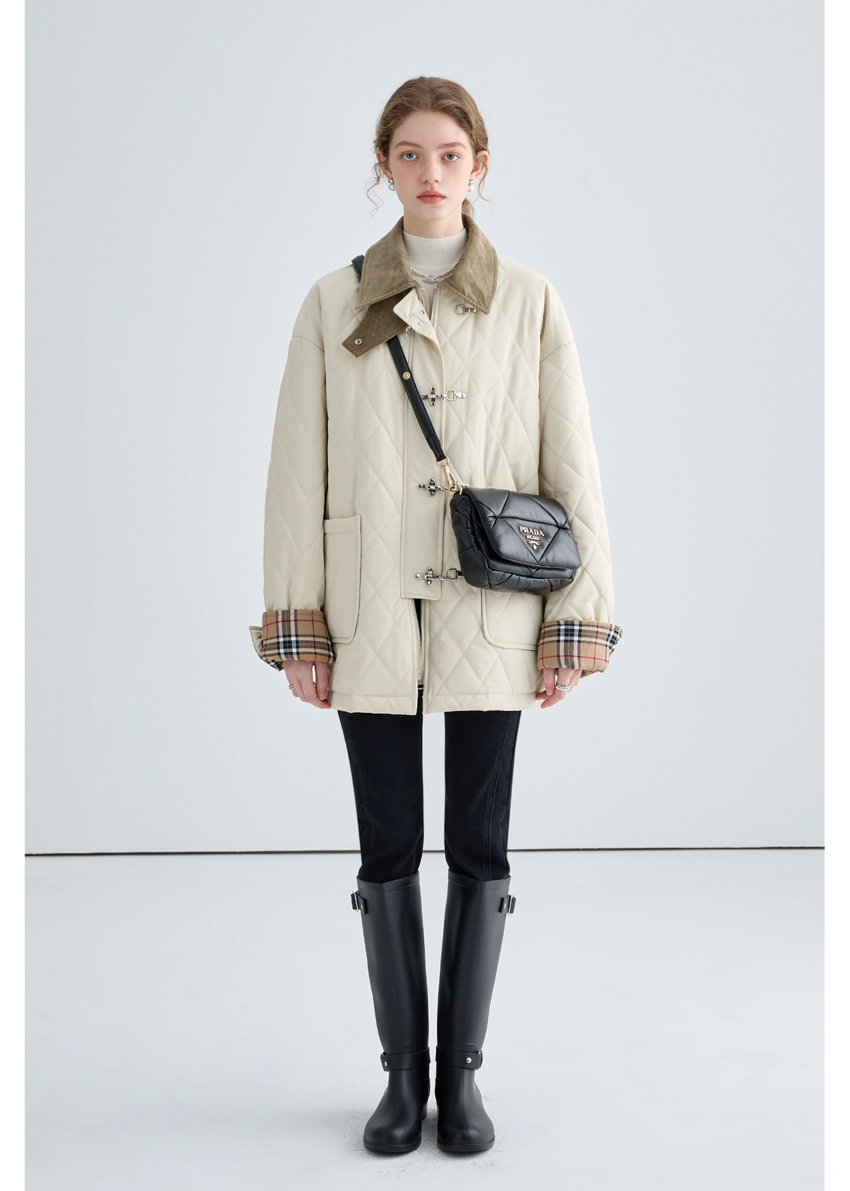 Full front view of women's beige quilted cotton jacket with brown corduroy collar, plaid cuffs and utility patch pockets