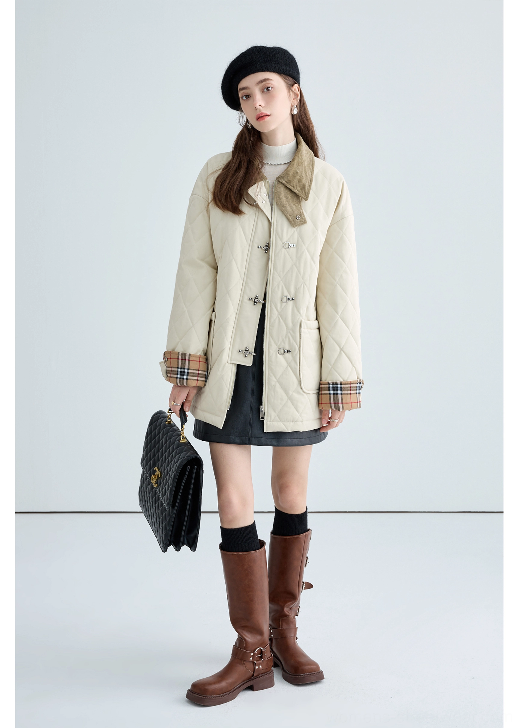 Detailed view of women's beige quilted jacket combining diamond stitching, brown corduroy and plaid cuff accents