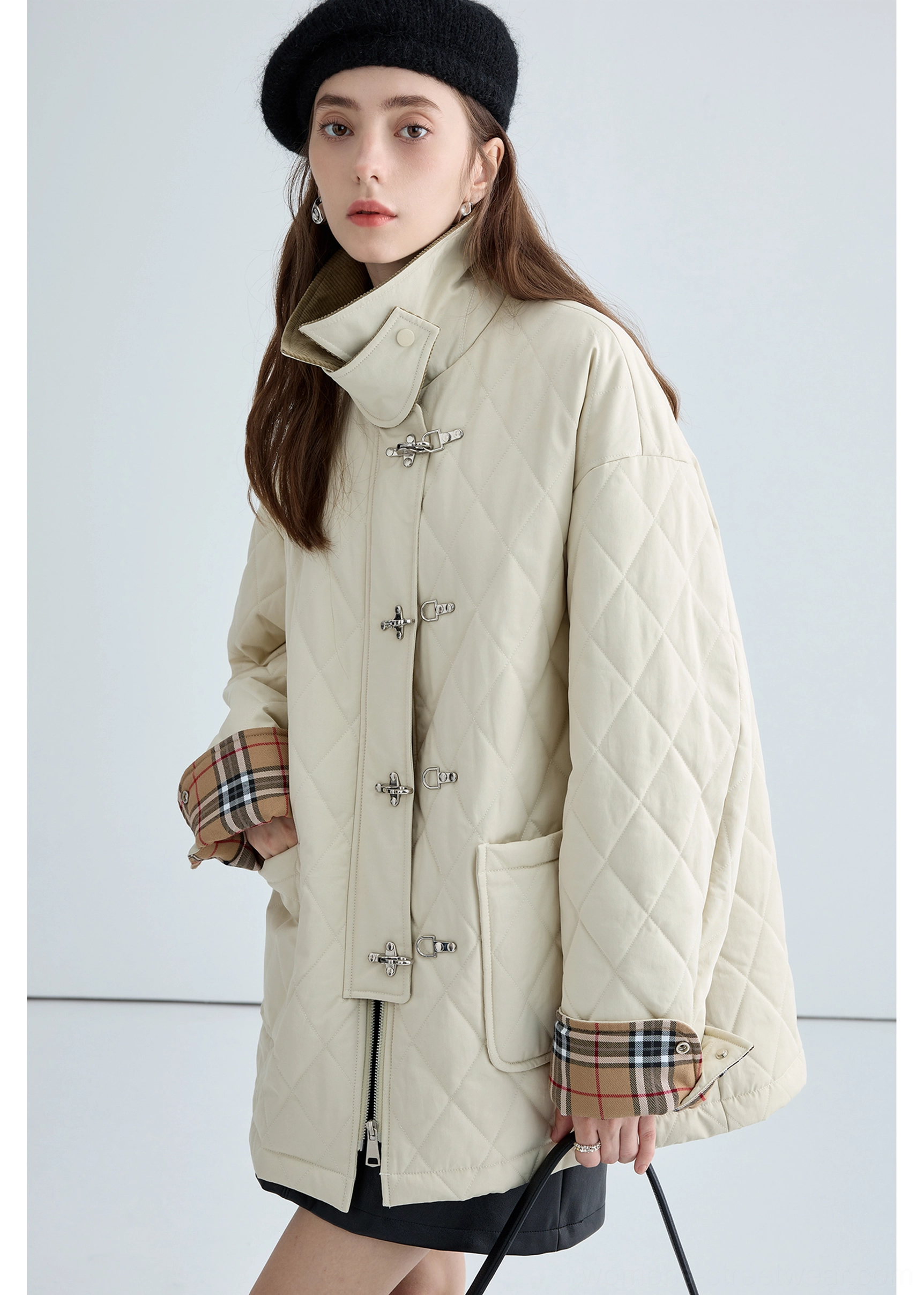 Women's beige quilted cotton work jacket with raised brown corduroy collar, plaid cuffs and polished metal buckle fasteners