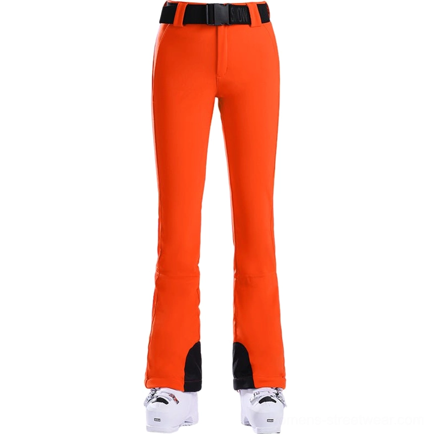 Women's orange belted flared ski pants with waterproof stretch fabric and contrast cuff panels