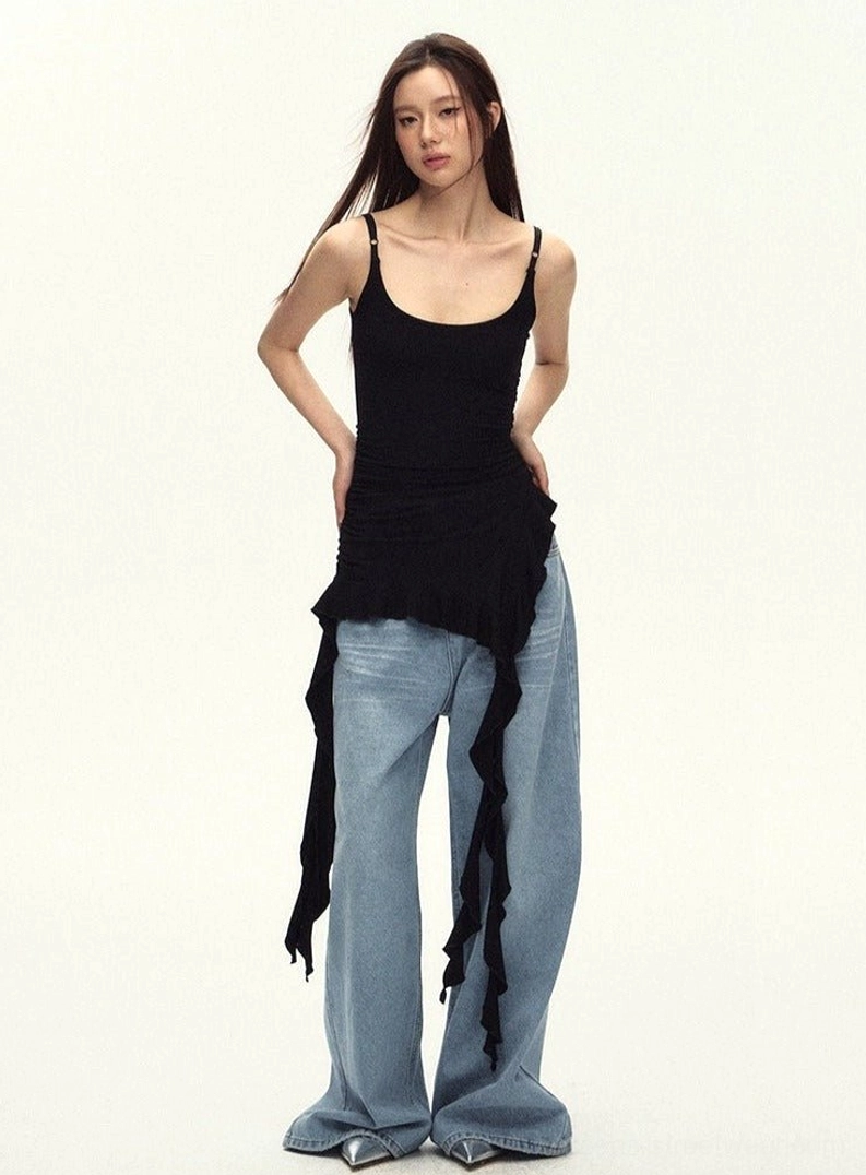 Women's black asymmetric cami top with textured ruching, scoop neckline, and statement ruffled hem