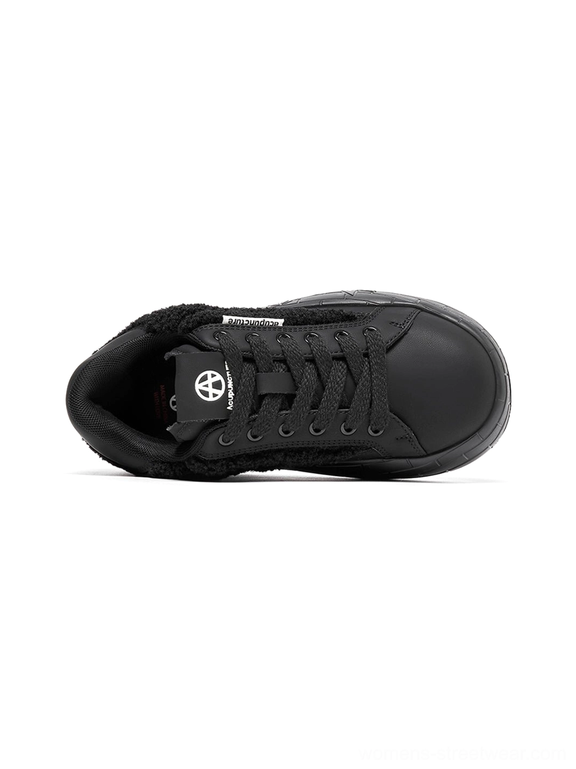 Women's black fleece platform sneakers featuring soft textured panels, structured toe caps, and a lifted sole