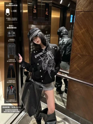 Women's black gothic angel asymmetric stand collar rock jacket worn with dark Y2K streetwear in elevator mirror