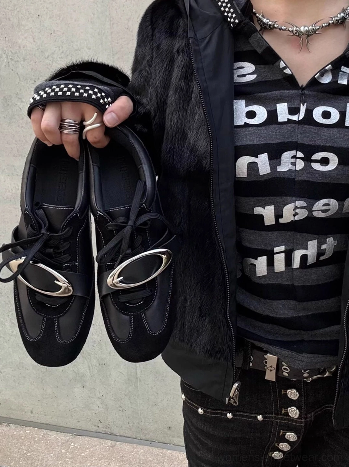 Black genuine leather German trainer sneakers featuring metallic vamp detail and classic low-top profile
