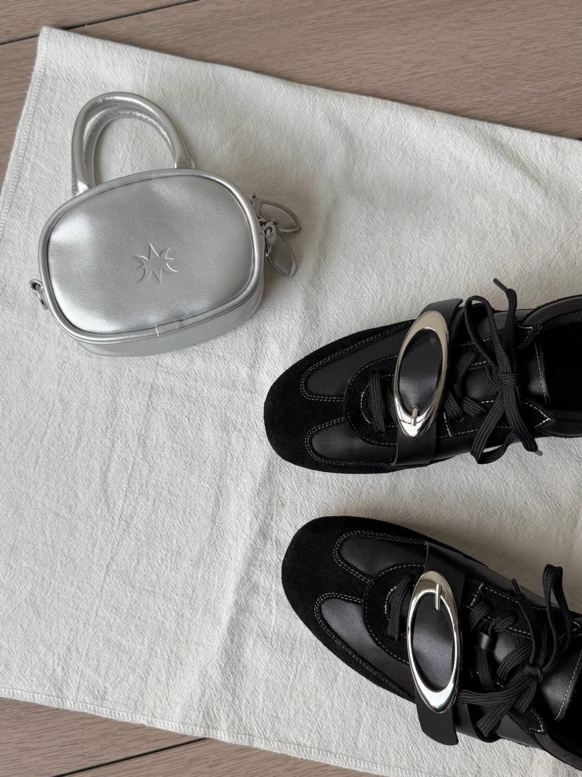 Minimalist black leather German trainer sneakers designed for contemporary women's streetwear outfits