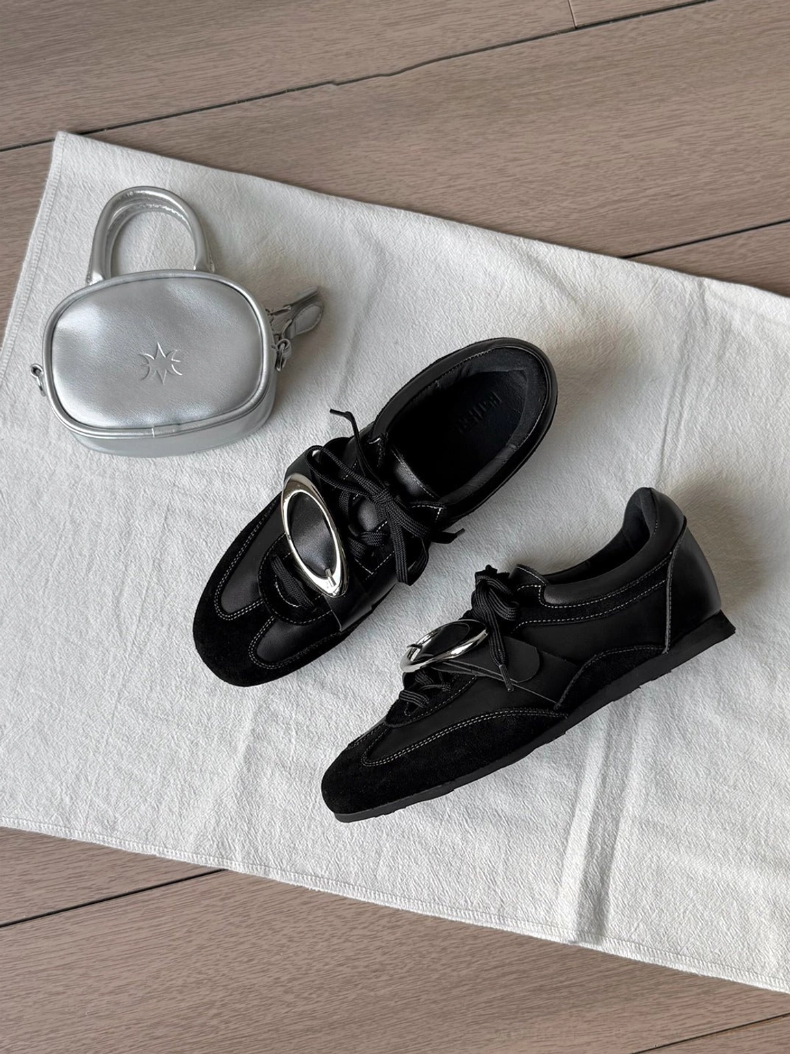 Black leather German trainer sneakers with metallic vamp panel and versatile everyday streetwear styling