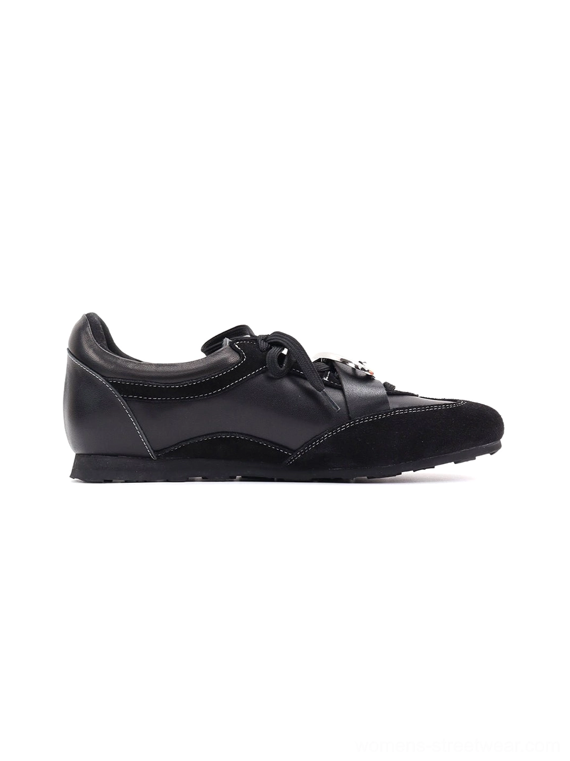 Women's black leather German trainer sneakers combining classic footwear design with avant-garde metallic detail