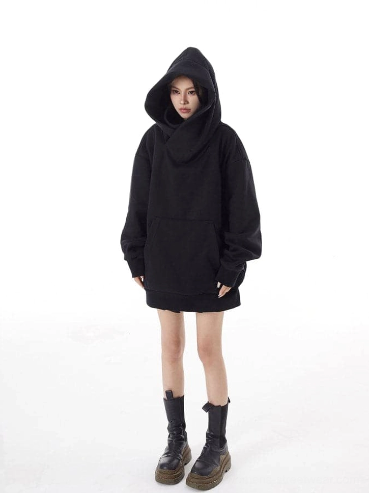 Women's black loose-fit hooded sweatshirt with sculptural high neck, mini skirt, platform boots, and alternative streetwear styling