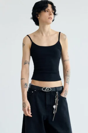 Women's black minimalist ribbed cropped camisole streetwear tank top styled with black wide-leg jeans front view