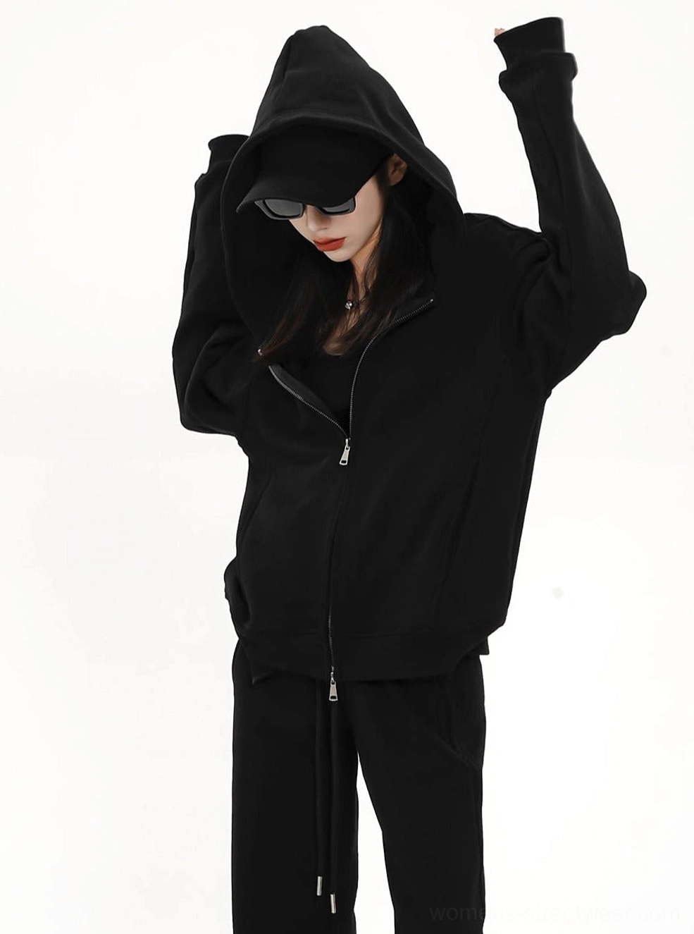 Women's black oversized zip-up hoodie jacket with attached hood and casual Y2K-inspired streetwear styling
