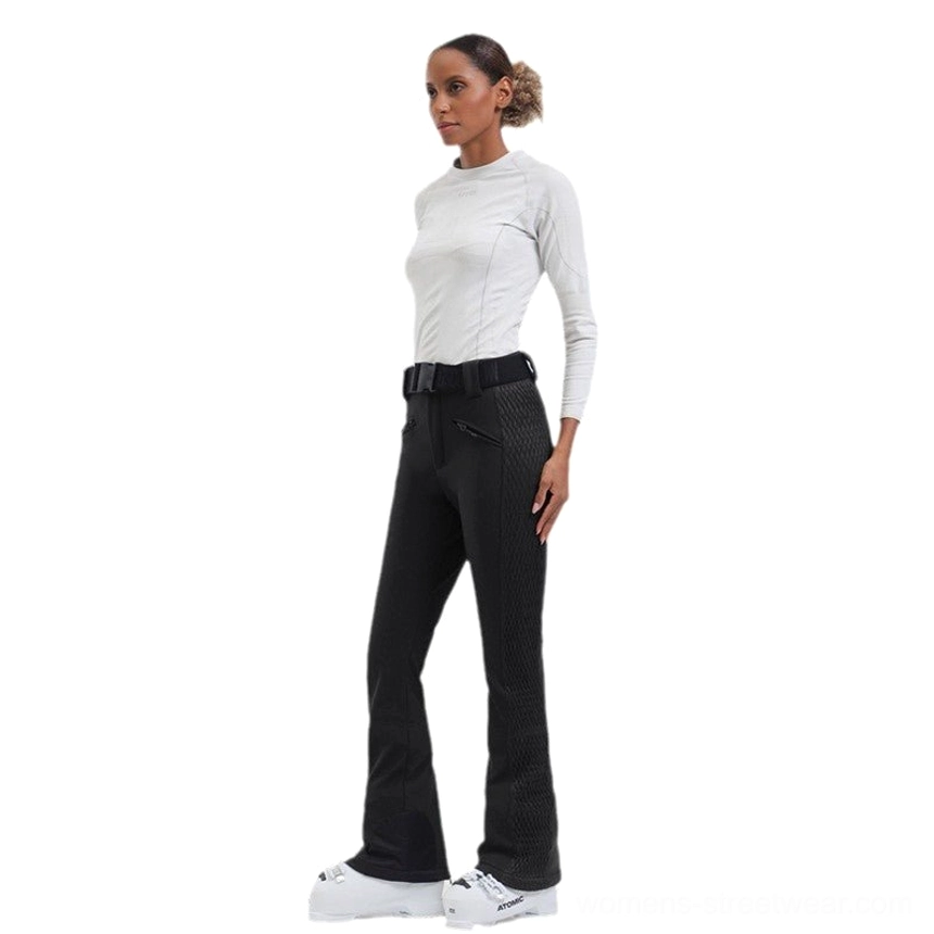Black women's ski pants shown from the side with quilted thigh panels, slim fit, flared legs, and matching waist belt