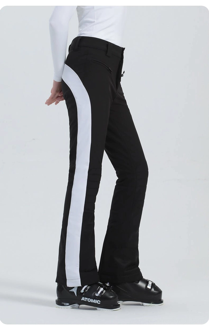 Black women's ski pants with wide white side stripe, fitted waist, flared leg, and performance ski boot styling