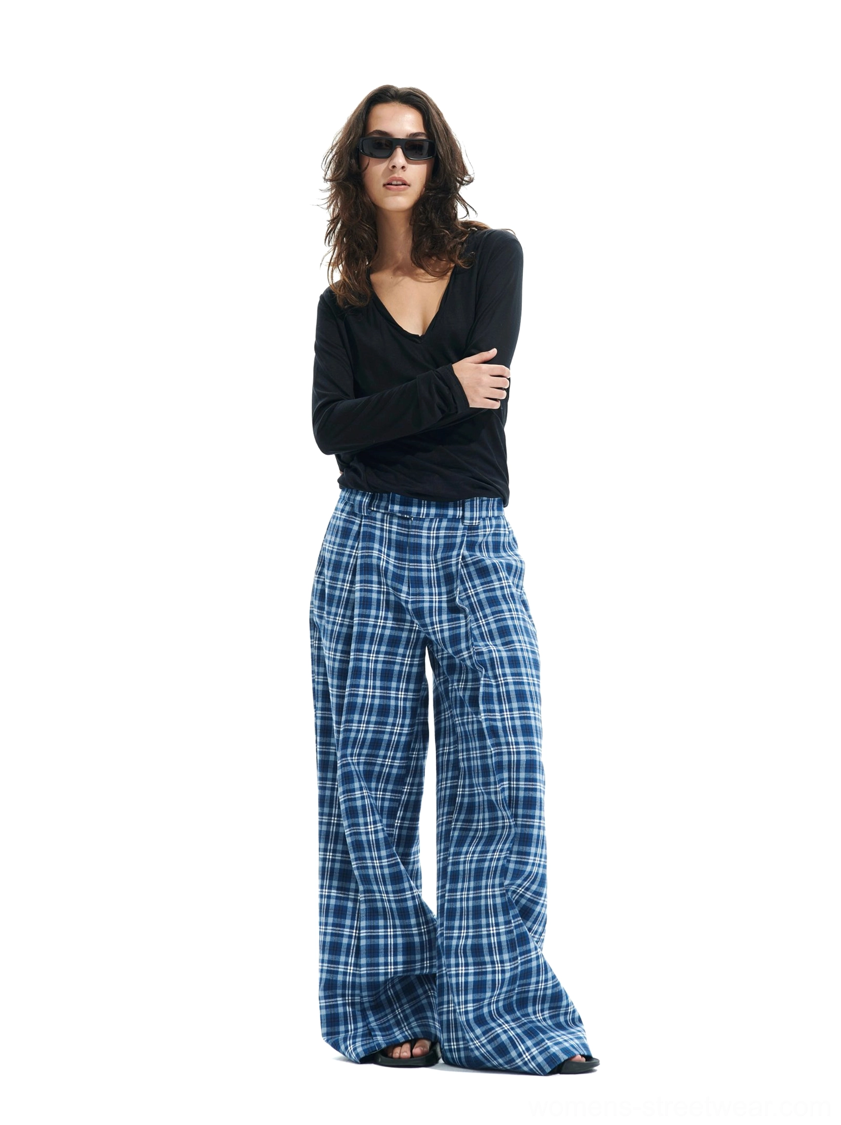 Women’s blue plaid wide-leg streetwear trousers styled with a black top and sunglasses in a relaxed Korean fashion look