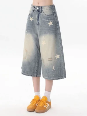 Women's blue star print vintage wash wide leg cropped denim jeans front view with distressed details