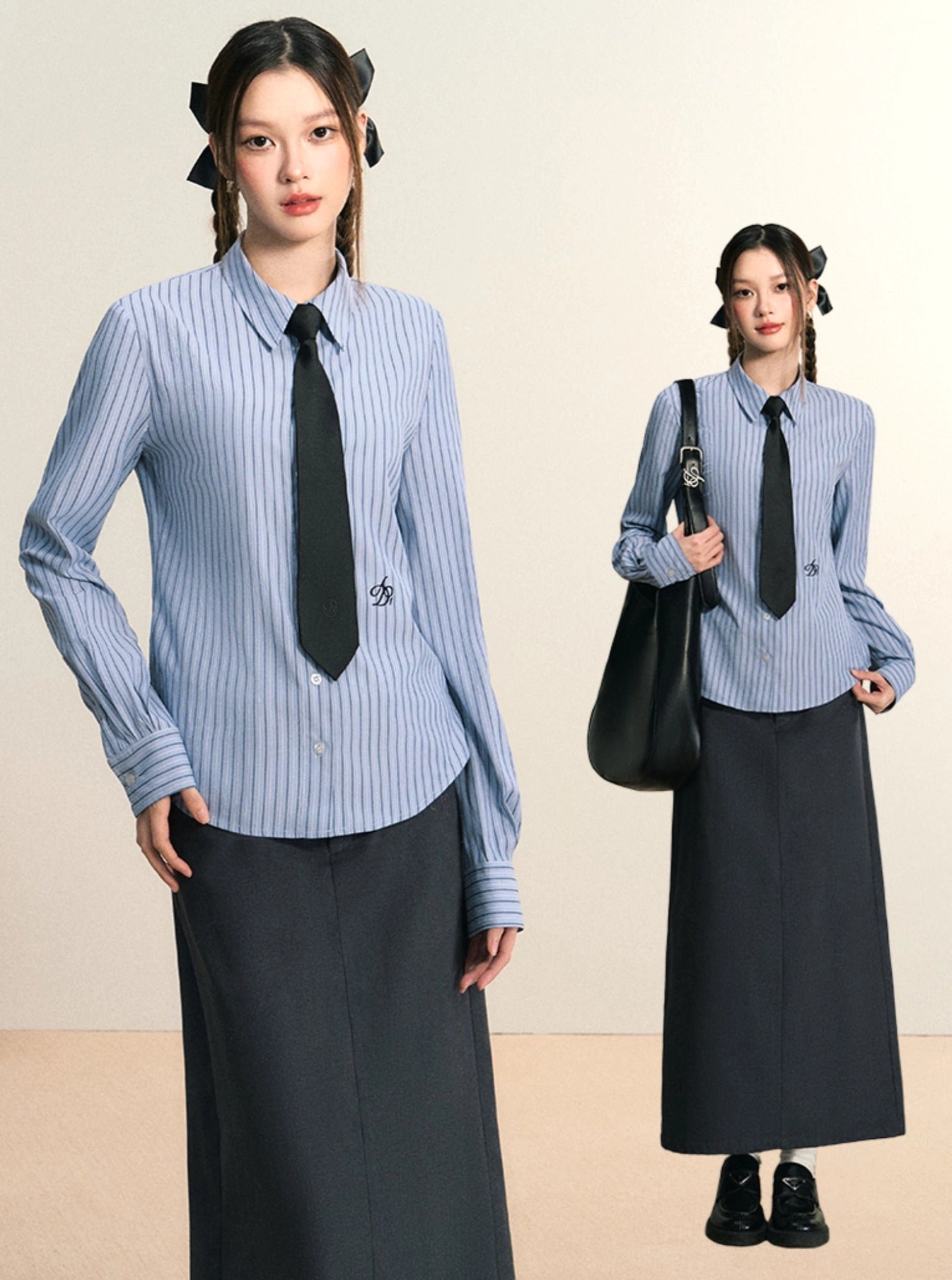Two models wearing blue striped women's preppy button down shirts with black ties and dark maxi skirts