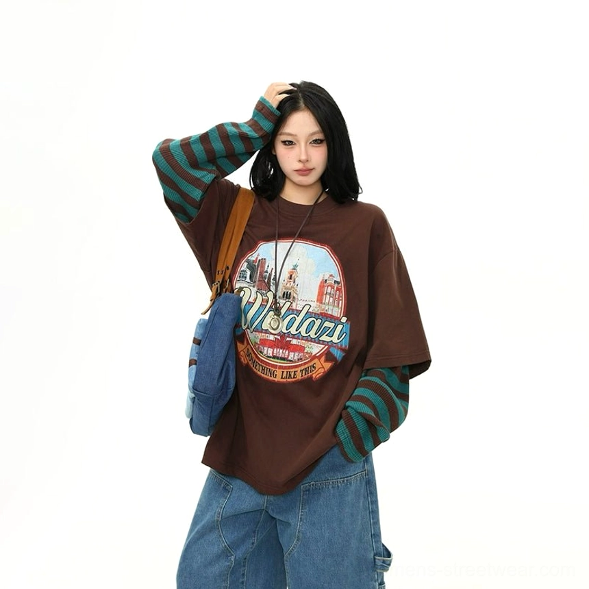 Front full outfit view of a women's brown cityscape graphic streetwear T-shirt with striped sleeves wide-leg denim and crossbody styling