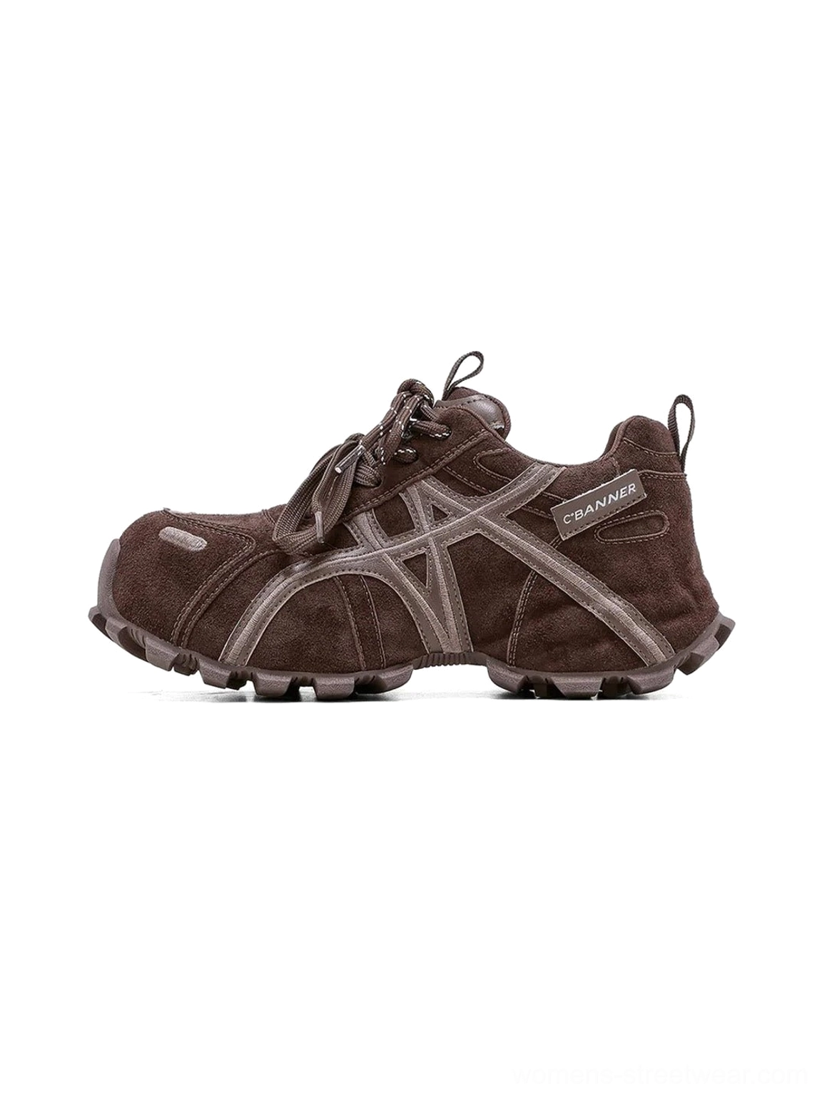 Women's brown cross-strap chunky trail runner sneaker in side three-quarter view with layered suede-inspired panels and rugged lug sole