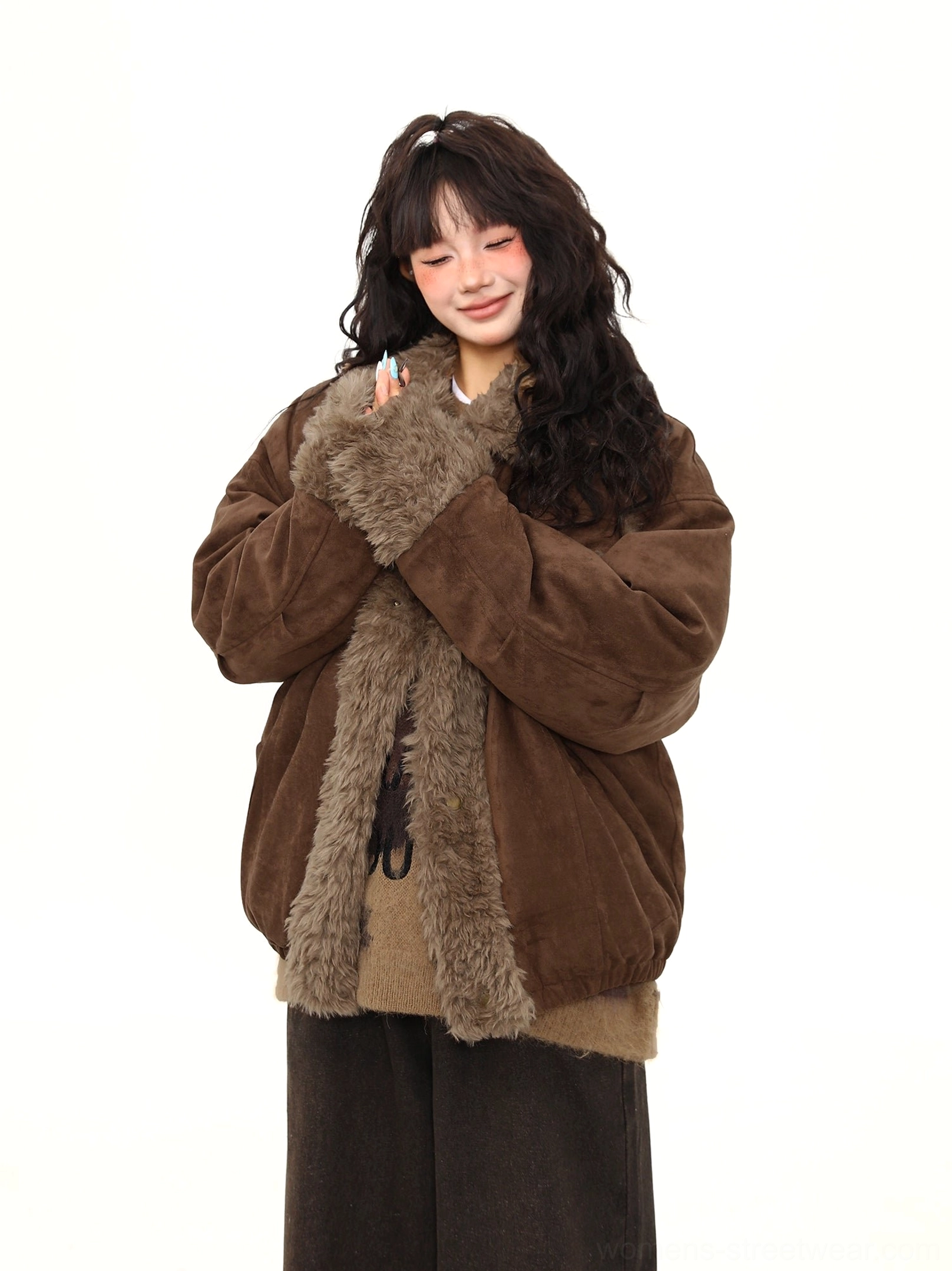 Women’s brown shearling aviator jacket styled as warm winter outerwear with fluffy collar and full front trim