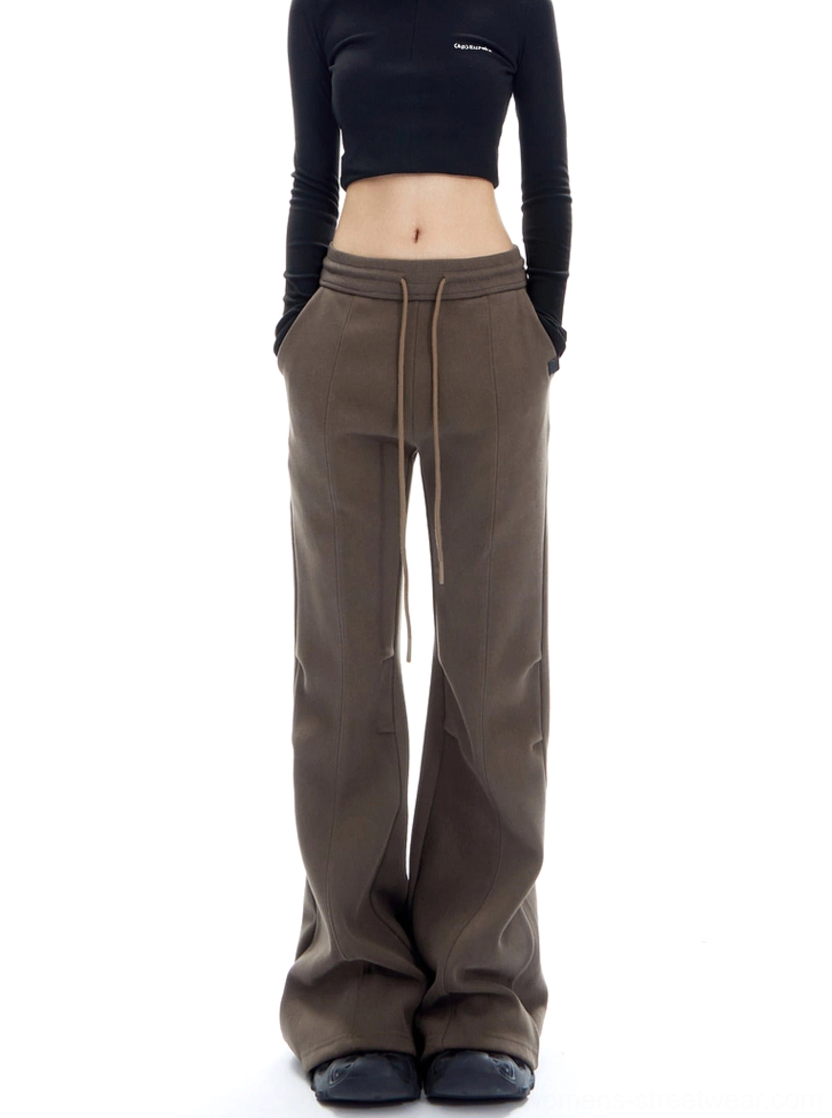 Brown wide-leg flared streetwear pants with front pockets and adjustable drawstring waist styled with a black cropped top