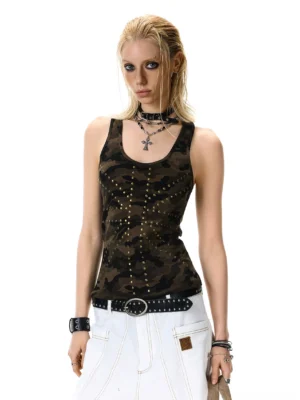 Front view of a women's camo studded racerback tank top with all-over metal studs styled with white cargo pants and a vintage handbag