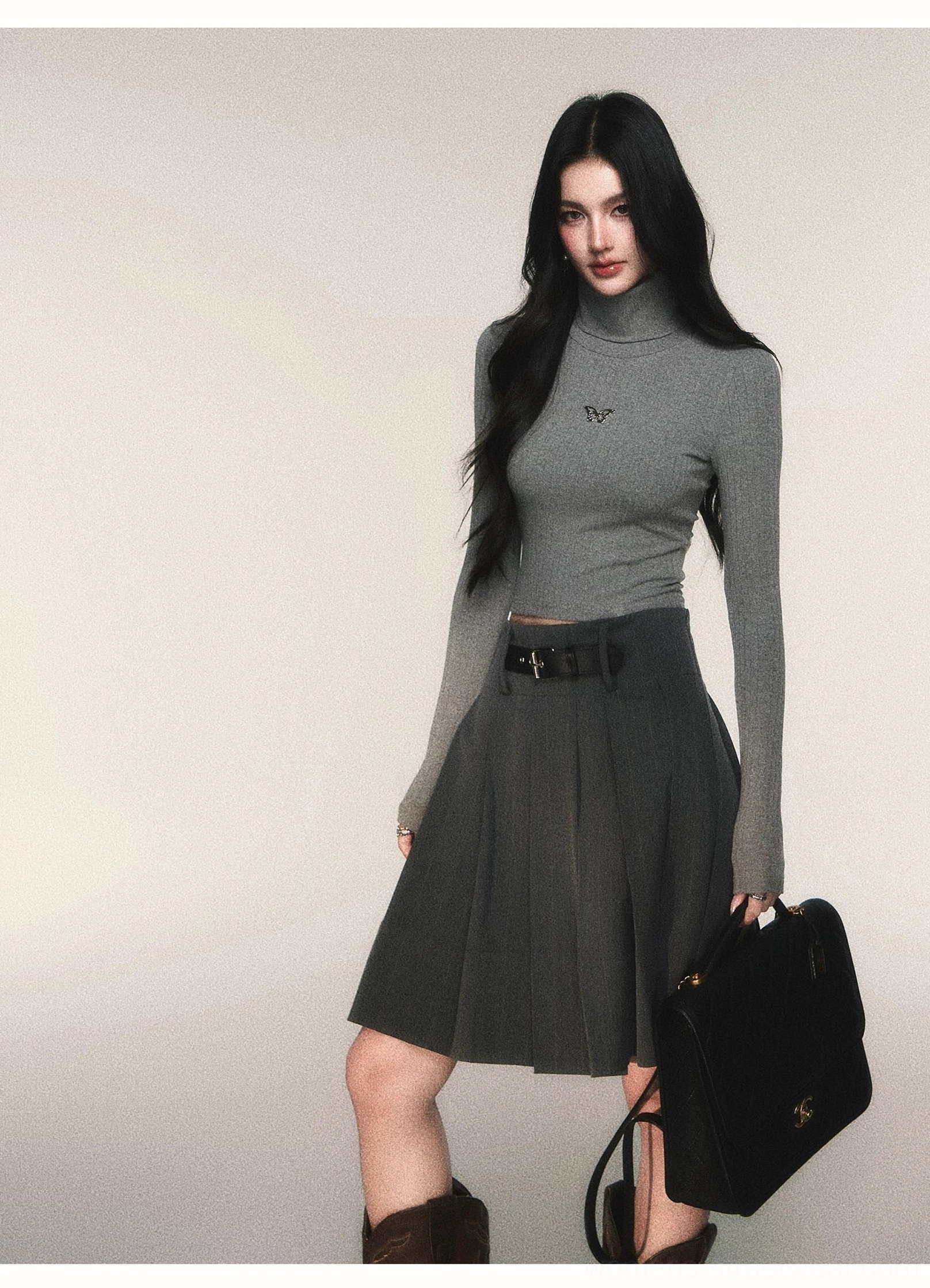 Women's charcoal pinstripe pleated midi skirt with detachable belt styled in a refined preppy streetwear outfit
