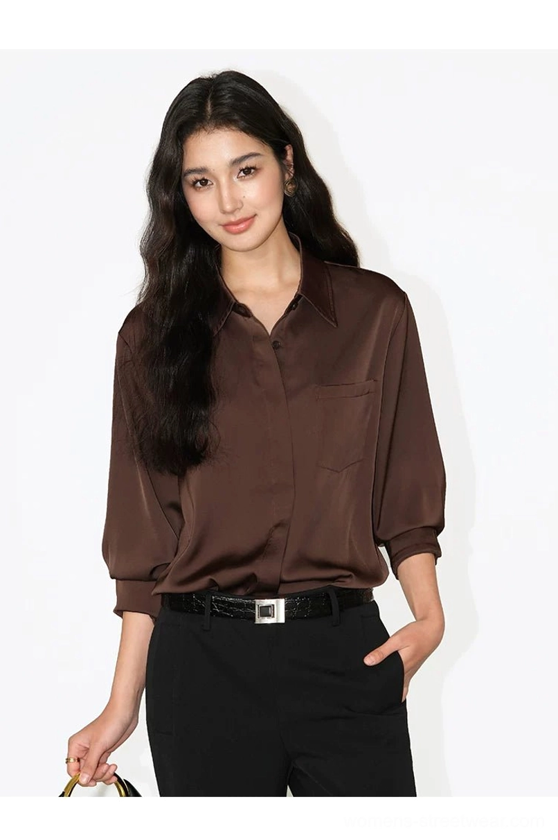 Deep coffee brown women's satin draped pocket shirt with black tailored trousers and a leather belt