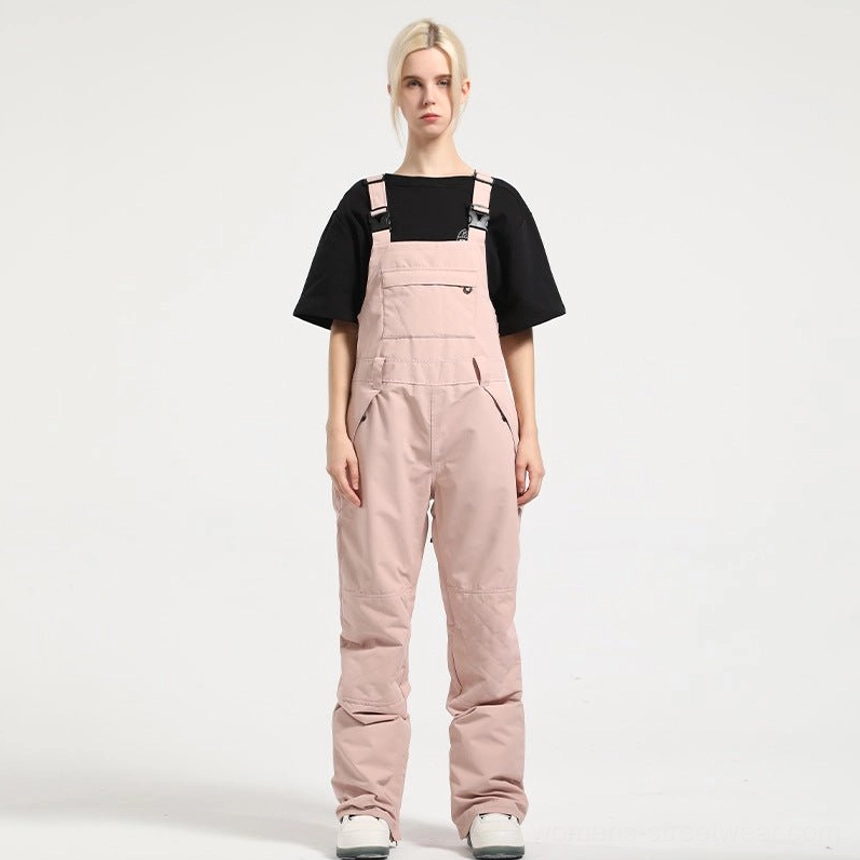 Women's streetwear bib snow pants featuring insulated construction, technical shell fabric, and boot-ready hems